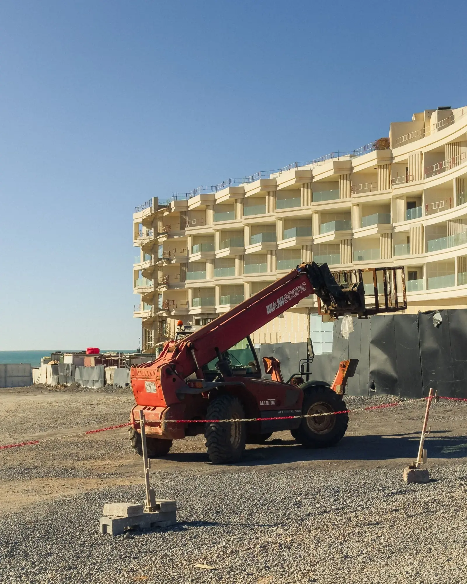 Construction vehicle beside a building undergoing exterior works
